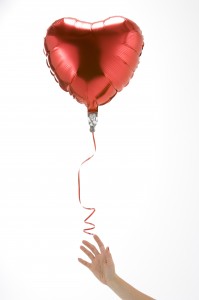 http://www.dreamstime.com/stock-images-hand-letting-go-heart-shaped-balloon-image12406774